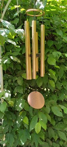 a chandelier hanging from a bush with green leaves at Le Jardin D' Épicure in Oderen