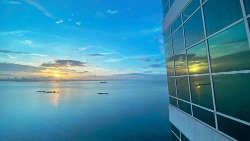 a view of the ocean from a building at sunset at Maritime Suites Penang in Jelutong