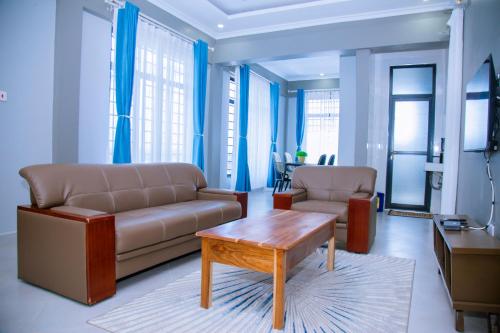 a living room with a couch and a coffee table at Eastern City Apartments in Dodoma