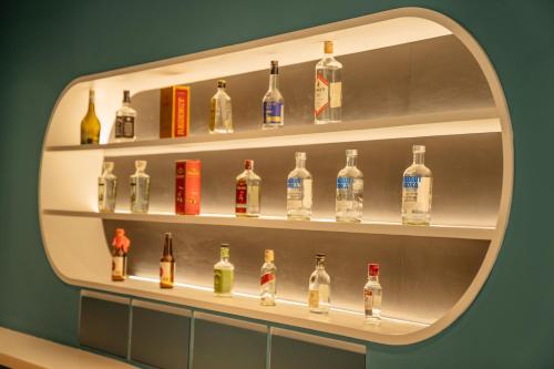 a shelf filled with lots of bottles of alcohol at VELA be Bangkok Siam in Bangkok