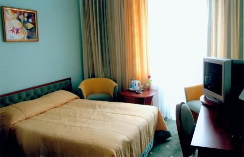 Postel nebo postele na pokoji v ubytování Hotel Mars
