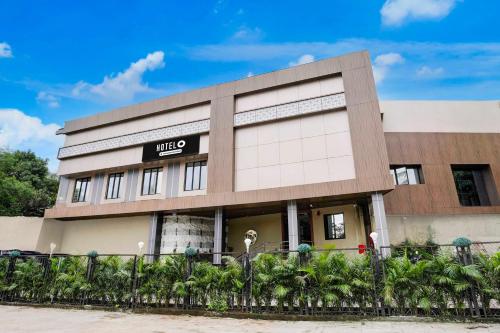 a building with a sign that reads nico at Collection O Ghodbunder Road Company Serviced in Sasupāda