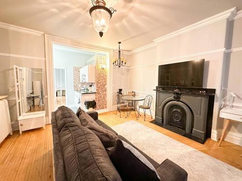 a living room with a couch and a television at Charlotte's Stay in Saint John