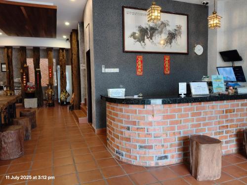 a bar in a restaurant with a brick wall at Sim Vintage Villa Langkawi in Kuah