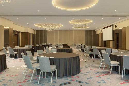 a large banquet hall with tables and chairs at Sheraton Grand Tbilisi Metechi Palace in Tbilisi City
