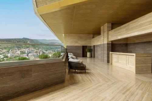 a living room with a view of a city at Sheraton Grand Tbilisi Metechi Palace in Tbilisi City