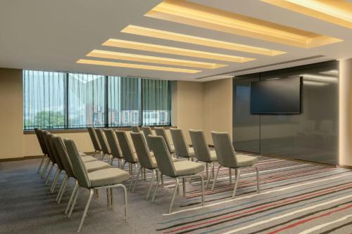 a conference room with chairs and a flat screen tv at Sheraton Grand Tbilisi Metechi Palace in Tbilisi City