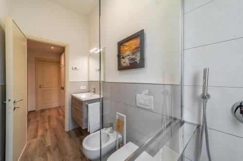 a bathroom with a toilet and a sink at The Olive Suite in Cerbaia