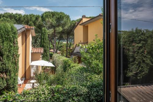 a view from a window of a yard with an umbrella at The Olive Suite in Cerbaia