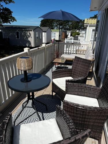 a balcony with chairs and a table and an umbrella at 43 Harbour View in Poole