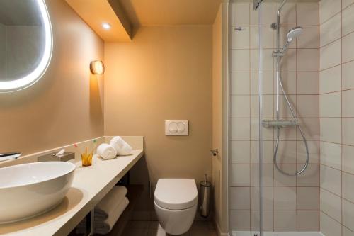 a bathroom with a toilet and a sink and a shower at lyf Gambetta Paris in Paris