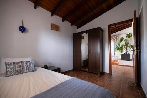 a bedroom with a bed and an open door at La Casa del Risco in El Pinar del Hierro