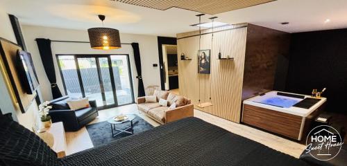 a living room with a couch and a table at Luxury Loft Home Sweet House in Oupeye