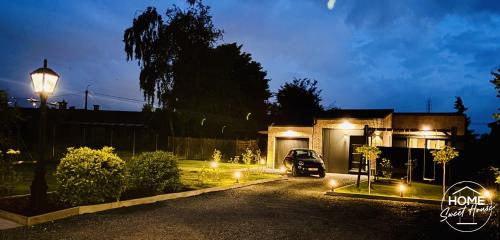 a car parked in front of a house at night at Luxury Loft Home Sweet House in Oupeye