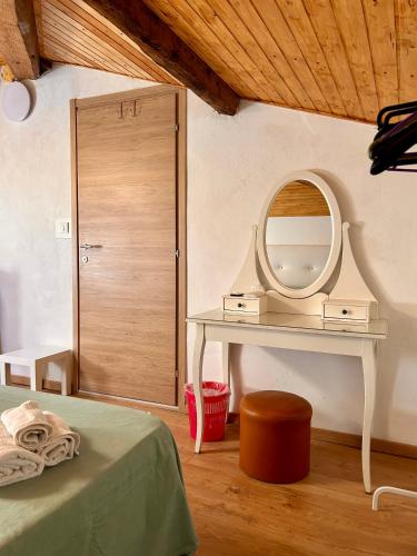 a bedroom with a dressing table and a mirror at Apt Versilia in Viareggio