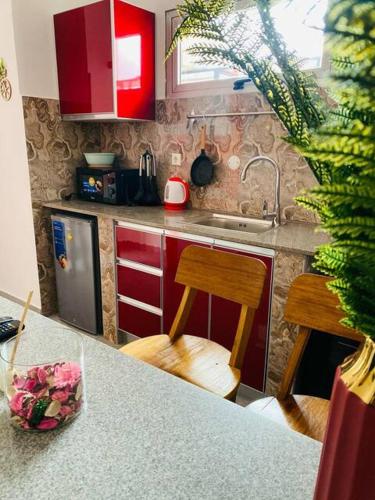 a kitchen with red cabinets and a counter top at JPCon in Luanda