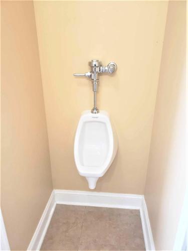 a bathroom with a urinal on a wall at Impressive Private Room in Washington DC in Washington