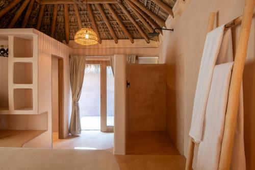 a bedroom with a bed and a room with a door at Casa Moka in Puerto Escondido