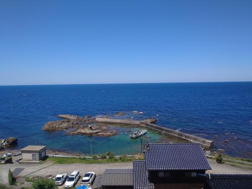 a group of cars parked next to a body of water at Iso Ocean Breeze Villa in Kyotango
