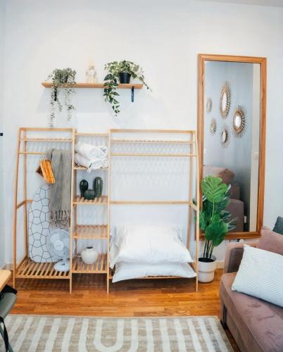 a room with a bunk bed with a mirror at Le petit coin vert de Paris in Montreuil