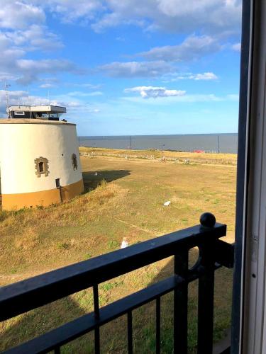 a view of the ocean from a balcony at Martello Sunrise - Luxury 3-bedroom Seaview Beach House in Felixstowe