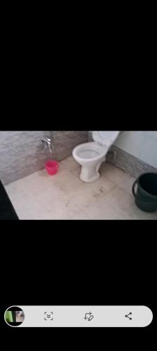 a picture of a bathroom with a toilet at Palghar Villa in Boisar