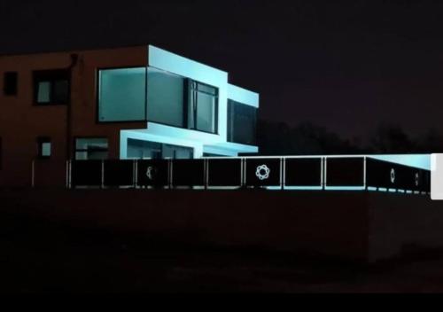 a building at night with its lights on at Melanie in Mazurija