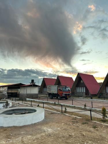 a truck parked in front of a group of buildings at Sylwan-O Sunrise Homestay And Restaurant in Shillong