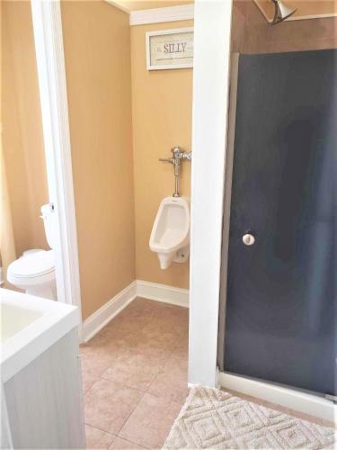 a bathroom with a urinal and a toilet in it at Outstanding Private Room in Washington DC in Washington