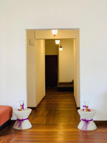 a living room with two tables and a couch at Seethawing by Cinnamon in Sita Eliya