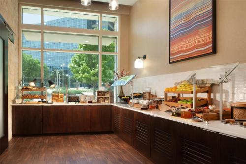 a bakery counter with a large window in a building at Hilton Dallas/Plano Granite Park in Plano