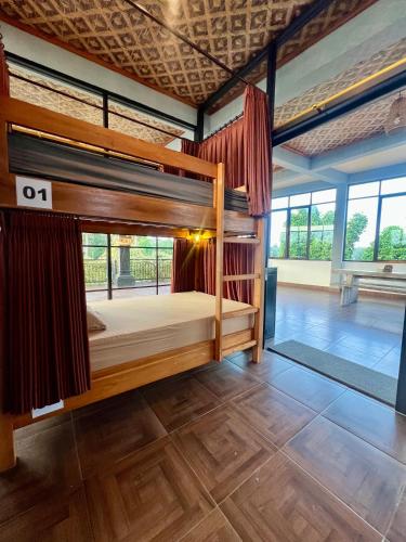 a bedroom with two bunk beds in a room at Hostel KARMA by SEAOM Villas in Ubud