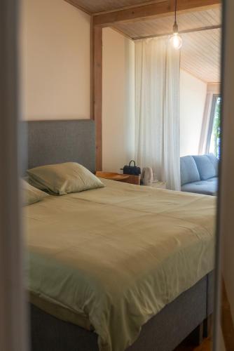 a bedroom with a large bed and a window at Guest House Vidlauči in Skulte