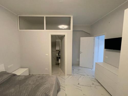 a bedroom with a bed and a television on a wall at Zerbi House in Reggio Calabria