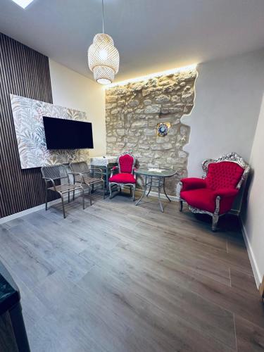 a room with a table and chairs and a stone wall at Las Casitas Del Mar in Alicante
