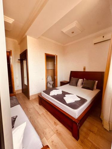 a bedroom with a large bed in a room at Iceberg Hotel in Tbilisi City