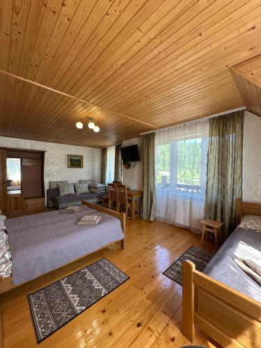 a large room with two beds and a couch at Гостинний двір Стефані in Tatariv