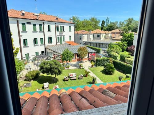 a view from a window of a yard and buildings at Hotel Villa Orio & Beatrice in Venice-Lido