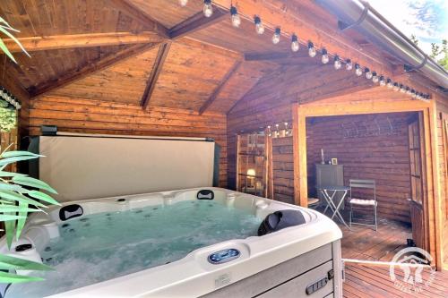 a jacuzzi tub in a wooden house at La gentilhommiere in La Bazouges-du-Désert
