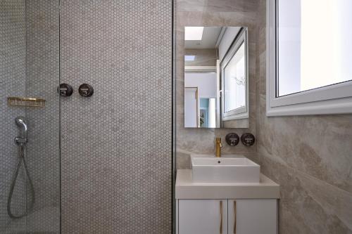 a bathroom with a shower and a sink and a mirror at Hotel Napa Suites (Adults Only) in Ayia Napa