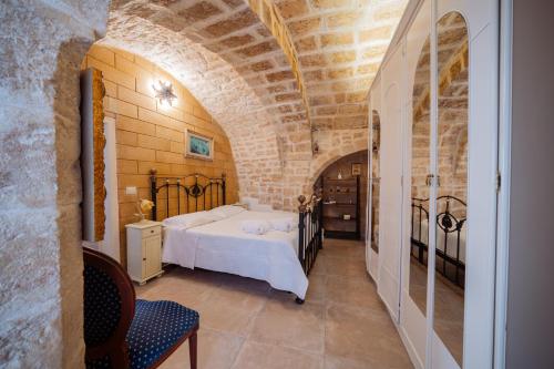 a bedroom with a bed in a brick wall at Casa Della Nonna - Centro Storico in Conversano