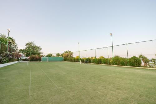 a tennis court with a net on top of it at Calypso Beach in Faliraki