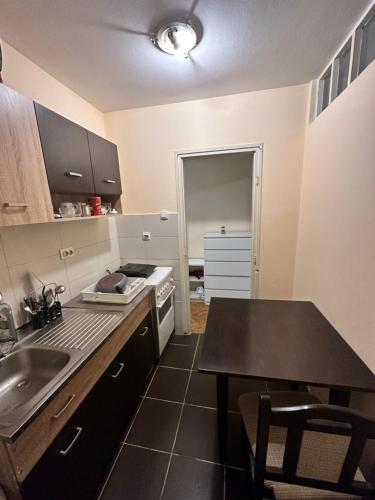 a kitchen with a sink and a stove top oven at Arena Apartmani in Belgrade