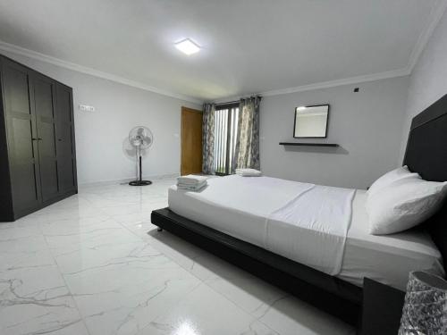 a bedroom with a large white bed and a window at Luxury house in Martil in Martil