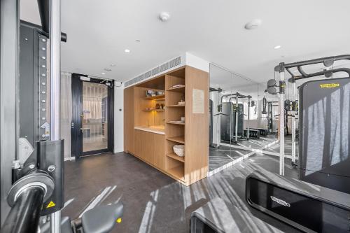 a room with a gym with a tv and a gym at The Cotton Tree - Luxury 3BR Apt Pool Gym BBQ Free Prkg 1min to Beach in Maroochydore