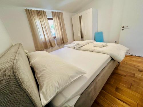 a bedroom with two beds and a window at Apartment Novigrad Holiday in Novigrad Dalmatia