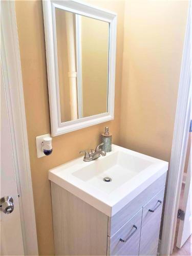 a bathroom with a white sink and a mirror at Inviting Private Room in Washington DC in Washington
