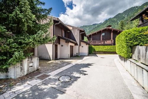 an empty street in front of some houses at Eden Hotel, Apartments and Chalet Chamonix Les Praz in Chamonix-Mont-Blanc