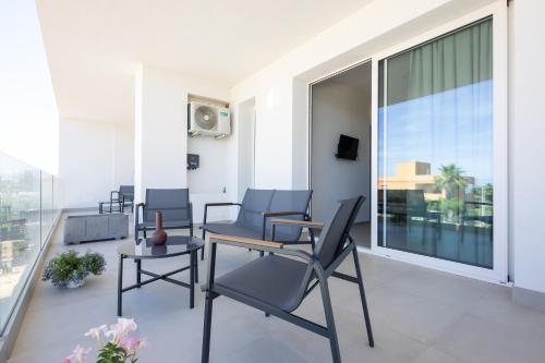 a living room with chairs and a table on a balcony at Dara Holiday Apartments in Marsala