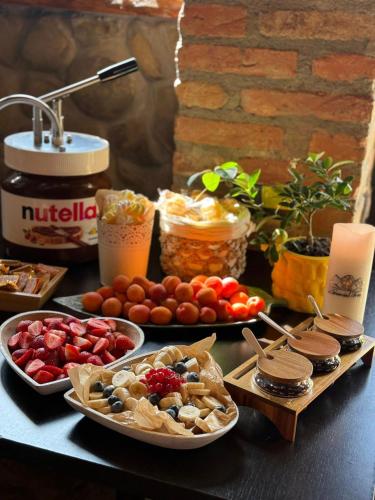 a table topped with plates of food and drinks at Domeniul Toma in Valea Dobîrlăului